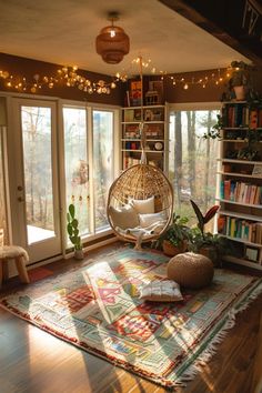 a living room filled with lots of furniture and bookshelves on top of a wooden floor