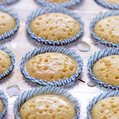 several cupcakes with icing on them sitting in a muffin tin