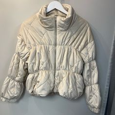 New With Tags Cream Long Sleeve Quilted Jacket For Winter, Beige Long Sleeve Quilted Puffer Jacket, Casual Cream Quilted Winter Jacket, Cream Casual Puffer Jacket For Fall, Casual Cream Puffer Jacket For Fall, Cream Puffer Outerwear For Cold Weather, Cream Hooded Puffer Jacket For Fall, Cream Puffer Jacket For Spring, Spring Cream Puffer Jacket