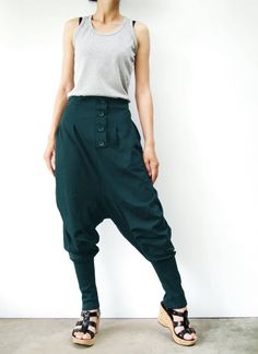 "* ALL ORDERS ARE SHIPPED VIA DHL EXPEDITED MAIL * Cotton jersey harem pants feature a drop crotch design with tapered pant legs, pleated front detail, side seam pockets, elastic back waistband, ribbed cuffs and four tucks at inseam create volume through leg. Roll up the ribbed cuffs hem for an utlra relaxed look! * Pull-on style * decorative pleats front and buttons detailed * Elastic back waistband provides a personal fit * Four tucks at inseam * Side seam pockets * Wide ribbed cuffs Measureme Green Cotton Pants With Buttons, Green Bottoms With Buttons For Fall, Casual Green Pants With Buttons, Green Fall Bottoms With Buttons, Green High-waisted Pants With Button Closure, Green Trousers With Buttons, Green High-waisted Pants With Buttons, Full-length Cotton Bottoms With Buttons, Full Length Cotton Bottoms With Buttons