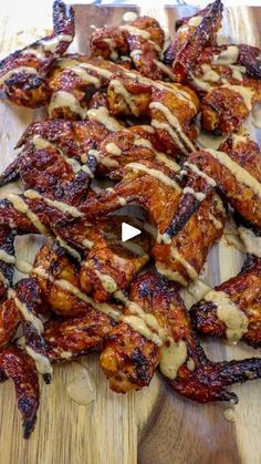 chicken wings covered in bbq sauce on a cutting board