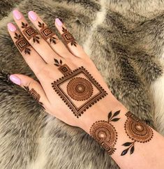 a woman's hand is decorated with hennap and geometric designs on it