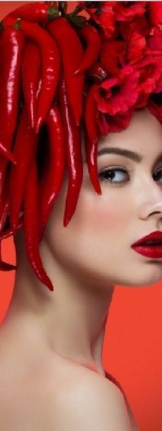 a woman with red chili peppers on her head and hair in the shape of a wreath