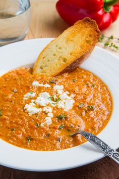 a white bowl filled with soup and bread