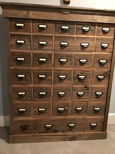 an old wooden filing cabinet with many drawers