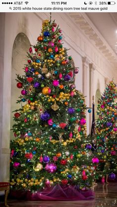 the christmas tree is decorated with colorful ornaments