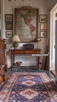 an antique rug is on the floor in front of a table with a lamp next to it