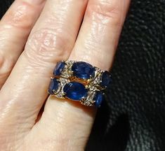 RARE and exquisite Kanchanaburi sapphire ring in excess of 6 carats accented with diamonds in a 14K gold setting The sapphires are the textbook perfect velvety blue coveted by gem collectors. This double band ring is an estate piece which I purchased in 1975. It is in fine condition. The setting is jeweler tested to 14K yellow gold. The gem carat weight is estimated since the gemstones are in the setting. The Kanchanaburi Sapphire gem gravels were discovered in 1918 and are located in the Bo Phl Luxury Sapphire Diamond Ring With 17 Jewels, Luxury Blue Sapphire Ring With 17 Jewels, Exquisite Sapphire Diamond Ring With 17 Jewels, Luxury Blue Diamond Ring With Single Cut Diamonds, Formal Blue Ring With Single Cut Diamonds, Formal Blue Rings With Single Cut Diamonds, Exquisite Multi-stone Blue Sapphire Ring, Exquisite Blue Multi-stone Sapphire Ring, Exquisite Yellow Gold Sapphire Ring