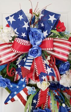 a patriotic wreath with red, white and blue flowers