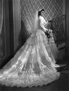 an old black and white photo of a woman in a wedding dress