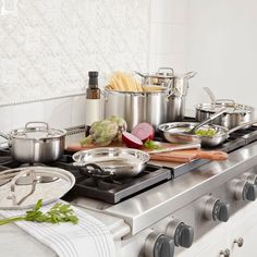 a stove top with many pots and pans on it