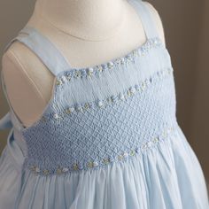 This Toddler Girls Smocked Sundress Is Most Precious!! The Dress Is Done In A Beautiful Soft Cloud Blue Voile, Which Overlays A White Liner, Creating A Wispy Silhouette (Cotton/Poly Blend For Easy Care). The Bodice Is Fully Smocked With A Lattice-Design Embroidered Overlay, Done In Blue Threading. Hand Embroidered Bullion Roses Border The Upper And Lower Lattice Design. The Square Neckline Is Trimmed In An Embroidered Floral Garland, With Matching Bullion Roses Placed Perfectly Within A Chevron Hand Smocking Tutorial, Roses Border, Smocked Sundress, English Smocking, Smocking Designs, Smocking Embroidery, Aqua Blue Dress, Smocking Tutorial, Mock Dress