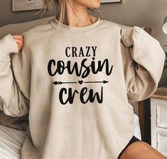 "The perfect way to celebrate family and show off your love for your cousins. These Custom Cousin Crew Shirts are designed to bring your family together and create a sense of unity and belonging. The Team Cousin Shirt design features a fun and playful slogan, \"Crazy Cousin Crew Tee,\" which is sure to put a smile on everyone's face. GREETINGS FOR VISITING OUR STORE  *Our item is the perfect birthday gift for your friends, family members, or just treat yourself! Designed, printed and shipped in USA. *A lightweight cotton crewneck tee that is a breathable and soft fabric. It is durable to keep you cool, comfy and relax *Machine washable *This soft cotton short sleeve t-shirt has double-needle seams for reinforcements, crisp and bold graphics and a unisex fit that is ideal for both men and w Graphic Tee Crew Neck Tops For Family Gatherings, Graphic Tee With Crew Neck For Family Gatherings, Family Funny Text Crew Neck Tops, Casual Tops With Custom Print For Family Gatherings, Funny Crew Neck Tops For Family Events, Funny Crew Neck Tops For Family, Casual Relaxed Fit Tops For Family Gatherings, Crazy Cousin Crew, Cousin Crew Shirts