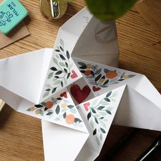 an origami bird on a wooden table