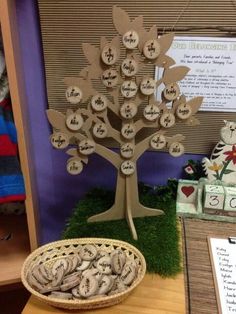 a table topped with lots of cookies next to a tree