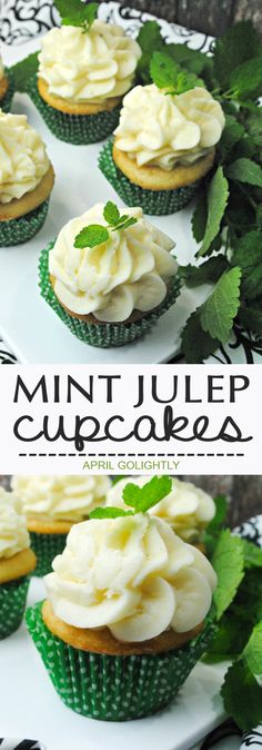 cupcakes with white frosting and mint leaves on top are sitting on a plate