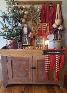 an old wooden cabinet with christmas decorations and other items on it's top shelf