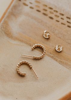 Ophelia is definitely on our minds! These gorgeous twisted hoops come in two different sizes so you can achieve either a classic or bold look. Whatever vibe you're going for, we know you'll look amazing. 🤩 Available in two sizes: Classic: 3/8" diameter Bold: 5/8" diameter Sold as a pair. Available in 14kt Gold Fill + Sterling Silver. Handmade in Eau Claire, WI. Our jewelry is handmade so each piece will be unique and may vary slightly from what is pictured. Everyday Twisted Yellow Gold Hoop Earrings, Twisted Yellow Gold Hoop Earrings For Everyday, Everyday Yellow Gold Twisted Hoop Earrings, Everyday Jewelry With Modern Twisted Style, Everyday Twisted Modern Jewelry, Backdrops Necklace, Second Piercing, Zodiac Rings, Hoop Charms