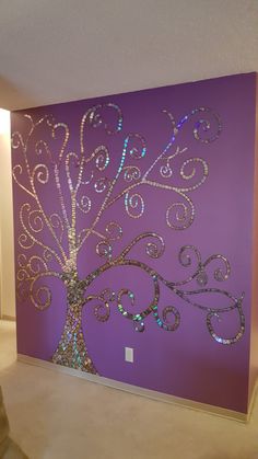 a purple wall with a tree painted on it