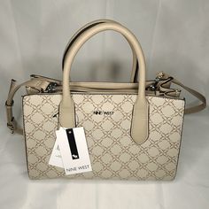 Nine West Allyce Handbag Purse Nyc532906 Mushroom Logo With Triple Entry And 2 Slip Pockets. 19" Adjustable Shoulder Strap And 8" Handle Drop. Magnetic Snap Closure. Faux-Leather In Beige Color With 9 Design Exterior. New With Tags. Nine West Bags Handbags, Cream Satchel For Office, Neutral Top Handle Bag With Detachable Handle, Beige Crossbody Bag With Handle Drop, Cream Satchel With Adjustable Handle In Tote Shape, Cream Satchel With Adjustable Handle And Tote Shape, Cream Satchel With Adjustable Handle Tote, Cream Rectangular Satchel With Adjustable Handle, Neutral Satchel Bag With Detachable Handle