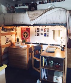 a bedroom with a loft bed, desk and shelves on the wall next to it