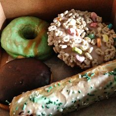 a box filled with donuts, pretzels and macaroni sprinkles