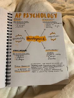 a spiral notebook with the words ap psychology written on it, and an orange marker