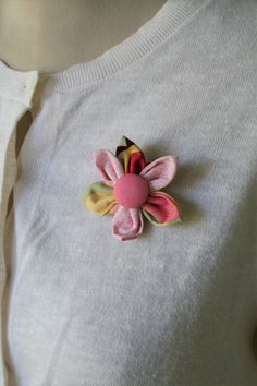 a white shirt with a pink flower on the front and yellow flowers on the back