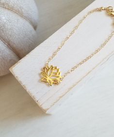 Minimal and Simplistic Style!A meaningful gold lotus flower bloom sits in the center with sparkling Gold Filled chain encircling the wrist. Solid lobster clasp. Your choice of length or you can order it to be adjustable making it easier for gift giving.Just like the Lotus, we too have the ability to rise from the mud, bloom out of the darkness and radiate into the world.All jewelry includes complimentary gift packaging.At Fabulous Creations, all our jewelry is handcrafted in the USA, inspired by Gold Chain Bracelet With Adjustable Chain For Spiritual Wear, Everyday Gold Jewelry In Flower Shape, Adjustable Gold Charm Bracelet With Delicate Chain, Dainty Gold Flower Shaped Bracelets, Gold Flower-shaped Jewelry With Lobster Clasp, Gold Spiritual Bracelets As A Gift For Her, Gold Flower Jewelry For Meditation, Delicate Adjustable Gold Charm Bracelet, Gold Flower Charm Bracelet As Gift