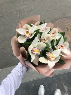 a person holding a bouquet of white flowers