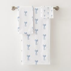 two white towels with blue bows on them