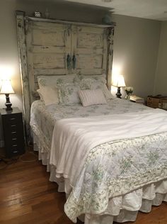 a bedroom with a bed made up in white linens