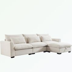 a white sectional couch with pillows on it