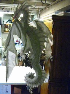 a dragon statue is hanging from the ceiling