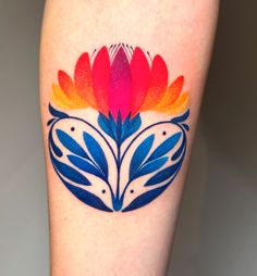 a colorful flower tattoo on the leg