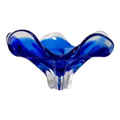 a blue glass vase sitting on top of a white table