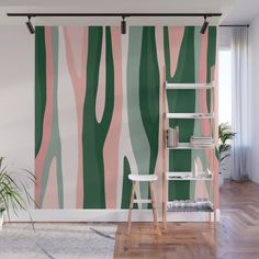 a wall mural with green, pink and white trees in the background on a wooden floor