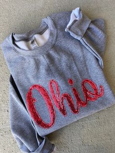 These Ohio sequin sweatshirts are super comfy as well as the perfect touch with boots and jeans!  Sweatshirts are unisex and the sweatshirt color can be changed!  ❗️Sizes: Toddler-2T-5T  Youth XS-XL  Adult S-XL  Adult 2X- Adult 3X  The graphite heather gray sweatshirt has a red sequin Ohio stitched onto the sweatshirt. If you would like to request a custom order, please send us a message!! Casual Long Sleeve Sweatshirt With Glitter Print, Casual Long Sleeve Glitter Print Sweatshirt, Casual Glitter Print Long Sleeve Sweatshirt, Long Sleeve Cotton Sweatshirt With Glitter Print, Cotton Glitter Print Long Sleeve Sweatshirt, Fall Sequin Long Sleeve Sweatshirt, Sequin Long Sleeve Sweatshirt For Fall, Sequined Long Sleeve Fall Sweatshirt, Ohio Sweatshirt