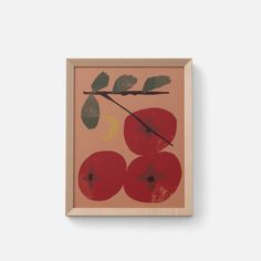 an abstract painting with red apples and green leaves on a pink background in a wooden frame