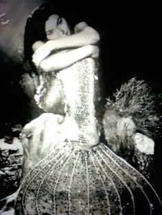 a black and white photo of a woman in a dress with sequins on it