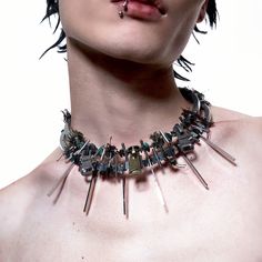 The Fifth Element Spike Necklace perfectly combines futuristic style with intricate craftsmanship. Featuring a double-layer circular chain design, the necklace is adorned with multiple metal zippers, spikes, and small beads, creating a bold, avant-garde aesthetic. Made from premium materials, this striking piece adds a dynamic and cutting-edge element to any outfit. Double-layer circular chain design Metal zippers, spikes, and bead accents Futuristic, avant-garde aesthetic Premium material const Avant Garde Aesthetic, The Fifth Element, Sneakers And Socks, Spike Necklace, Futuristic Style, Half Shirts, Fifth Element, Small Beads, Jean Accessories