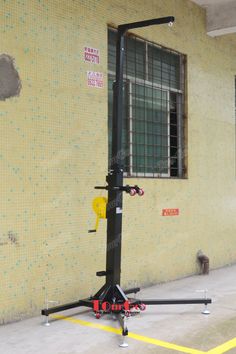 a gym equipment stand in front of a building with yellow tiles on the wall and windows