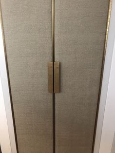 the door is closed and it has a handle on it's left hand side