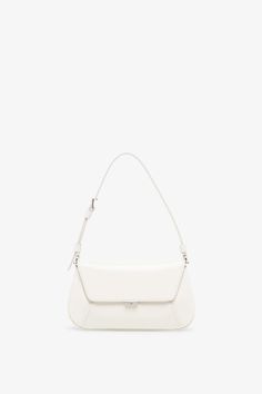 White leather bag from Amina Muaddi. The Ami mini bag is made of calf leather with silver finish hardware, a magnetic closure along with an inside mirror frame. It features an internal flat pocket and is complete with an adjustable strap.Measurements: L21 x H12 x W4 cmMade in Italy Luxury White Satchel Baguette Bag, Luxury White Baguette Bag With Removable Pouch, Luxury White Baguette Bag With Top Handle, White Shoulder Bag With Silver-tone Hardware, Modern White Satchel With Palladium Hardware, White Shoulder Bag With Palladium Hardware For Office, Classic White Flap Shoulder Bag, Timeless White Rectangular Flap Bag, White Satchel With Palladium Hardware And Top Handle