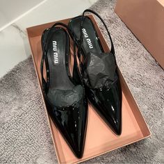 New, Never Worn Miu Miu Black Patent Leather Slingback Kitten Heels. Size 38. I’m Normally A 38.5 And These Fit So I Think They May Run A Bit Big. Incredibly Small White Scuffs Shown In Two Photos. Comes With Box, But No Dust Bag. 100% Authentic. Still For Sale On Frwd.Com For $910. From Website: These Patent Leather Slingback Pumps Blend Materials, Colors And Stylistic Codes Typical Of Dynamic Sports Shoes And Tropes Of Femininity. Patent Leather Upper With Rubber Sole Made In Italy Slingback S Designer Patent Leather High Heel Slingback Pumps, Designer Patent Leather Slingback Pumps High Heel, Patent Leather Open Heel Slingback Pumps For Evening, Luxury Black Ankle Strap Kitten Heels, Chic Patent Leather Slingback Pumps For Evening, Chic Evening Slingback Pumps In Patent Leather, Patent Leather Slingback Heels For Evening, Patent Leather Slingback Kitten Heels For Party, Designer Low Heel Slingback Pumps For Office