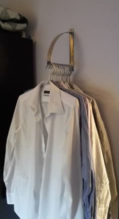 a white shirt hanging on a clothes rack