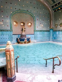 an indoor swimming pool with tiled walls and floor