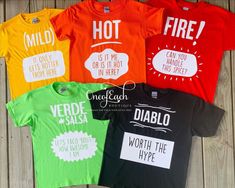 four different colored shirts with words on them