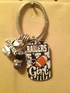 a keychain that has some sports related items on it and is attached to a wall