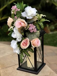 a vase filled with pink and white flowers